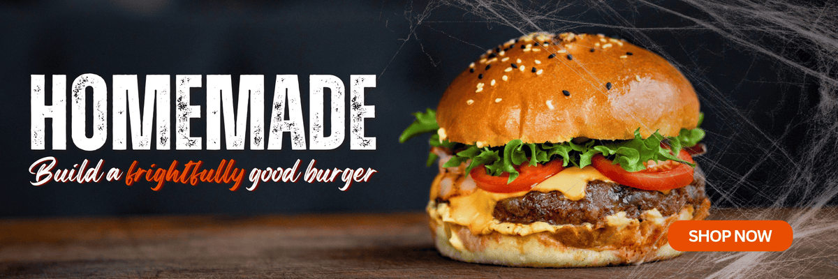 Halloween-themed banner featuring a homemade beef burger with cheese, lettuce and tomato, alongside the text “Homemade – Build a frightfully good burger” and a “Shop Now” button, with cobwebs in the background.