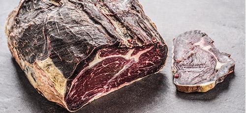 Joint of meat with a pre-sliced piece.