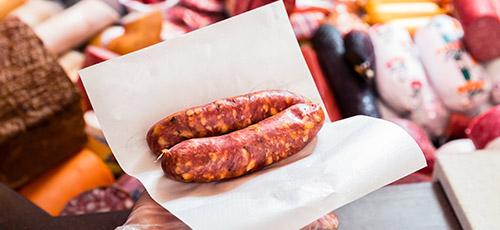 Sausages wrapped in butchers paper.