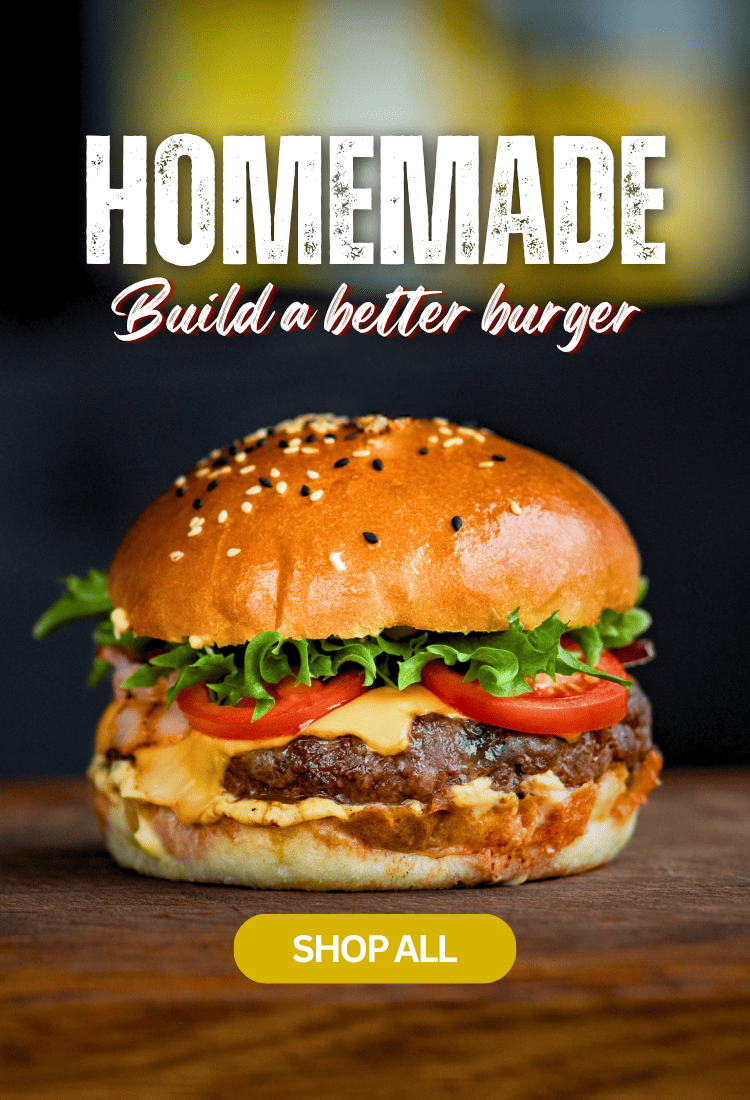 A close-up of a gourmet burger with a sesame seed bun, melted cheese, fresh lettuce, and tomato slices on a wooden surface. Large text at the top reads 'HOMEMADE Build a better burger' with a yellow 'SHOP ALL' button below.