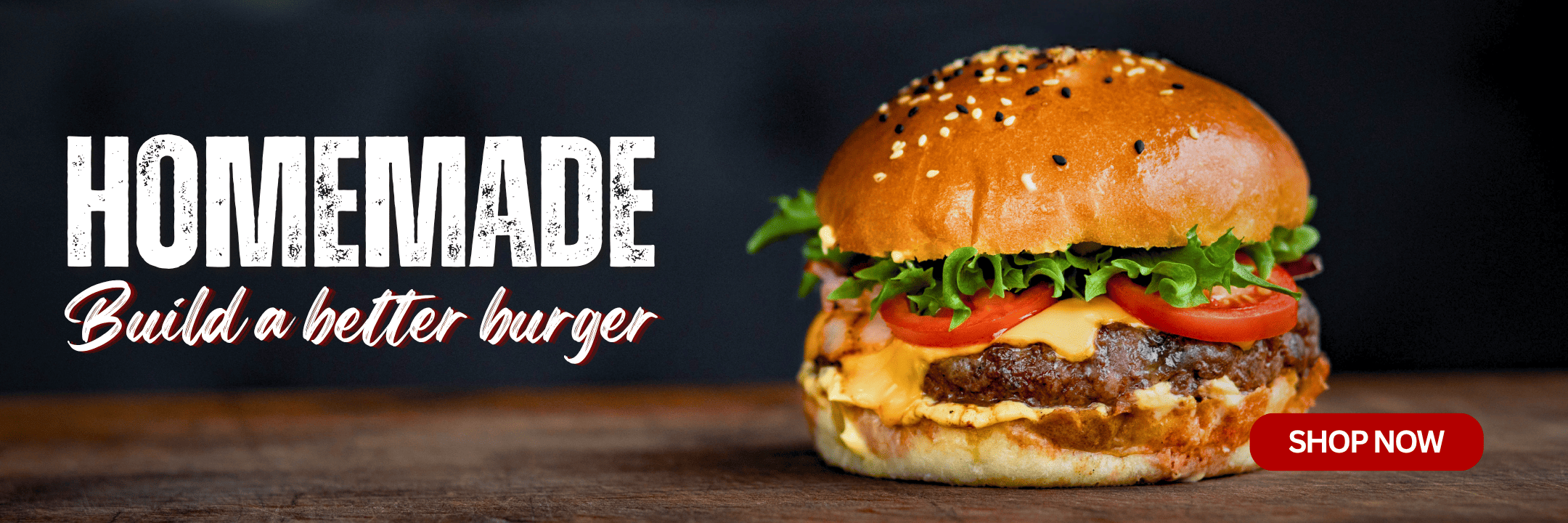 A close-up of a gourmet burger with a sesame seed bun, melted cheese, fresh lettuce, and tomato slices on a dark wooden surface. The left side features the text 'HOMEMADE Build a better burger' in white and pink lettering, with a red 'SHOP NOW' button on the bottom right.