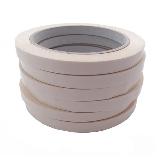 Stack of 6 white bag sealing tapes on rolls.